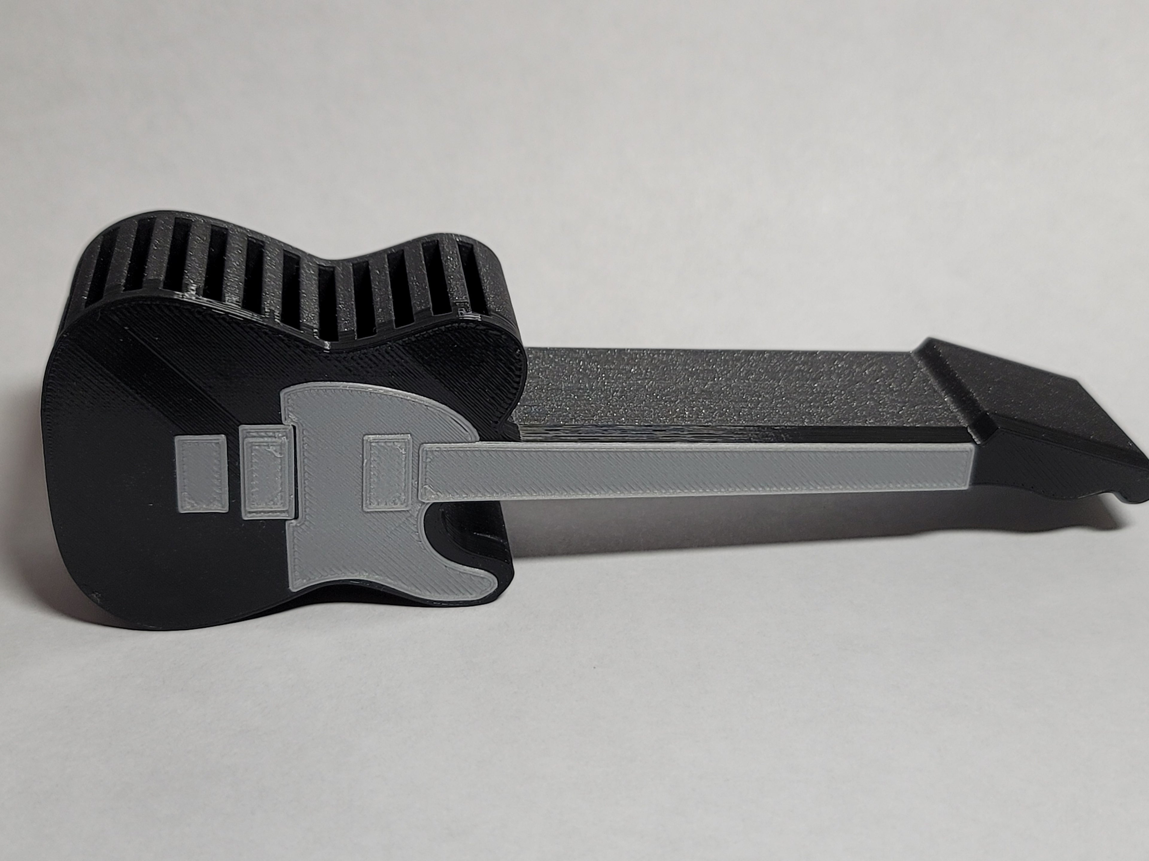 Telecaster-style guitar pick holder by Bryans3dPrints, black with gray inserts, keeps picks organized.