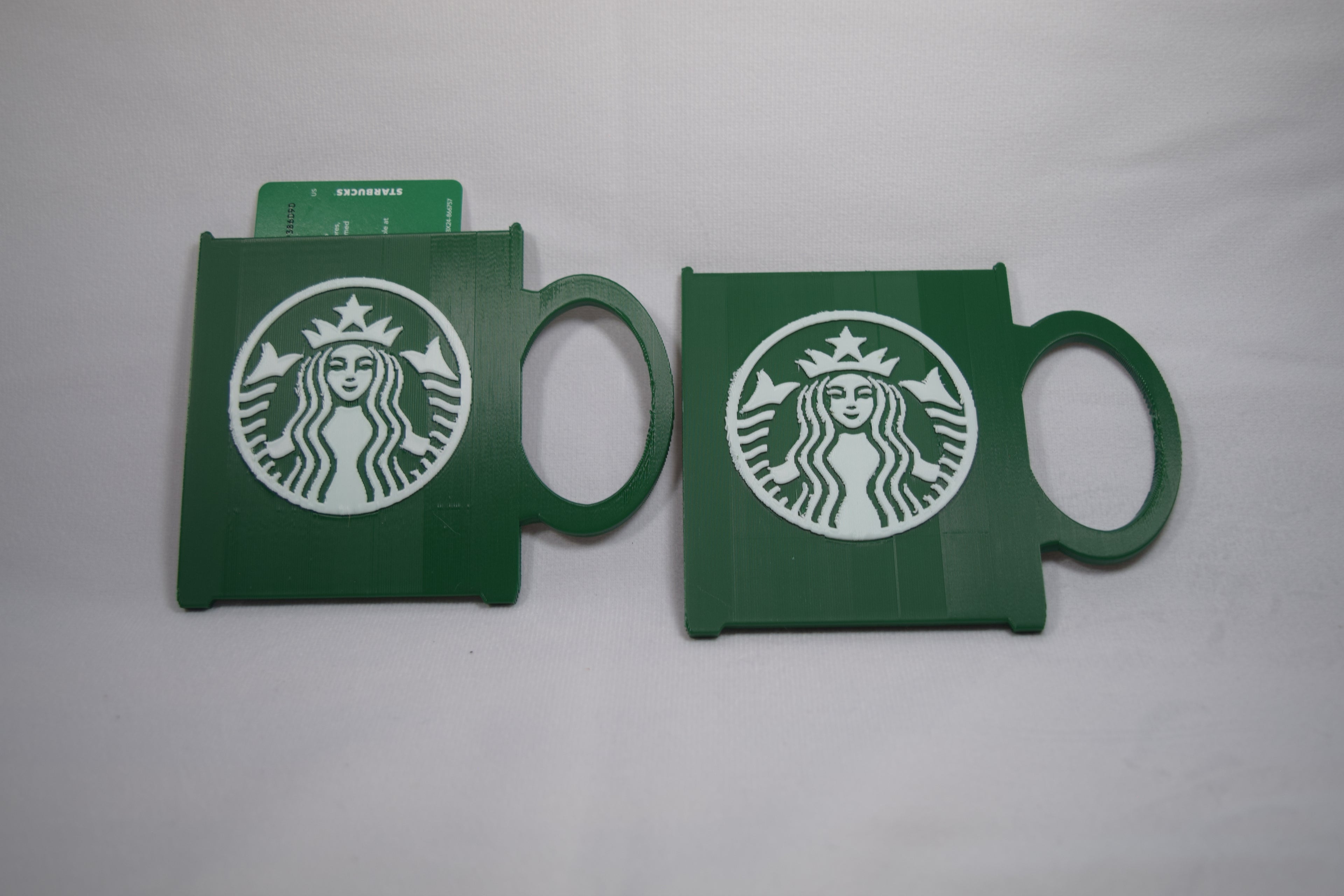 Starbucks mug gift card holder, green 3D-printed plastic with white Starbucks logo, two pieces.