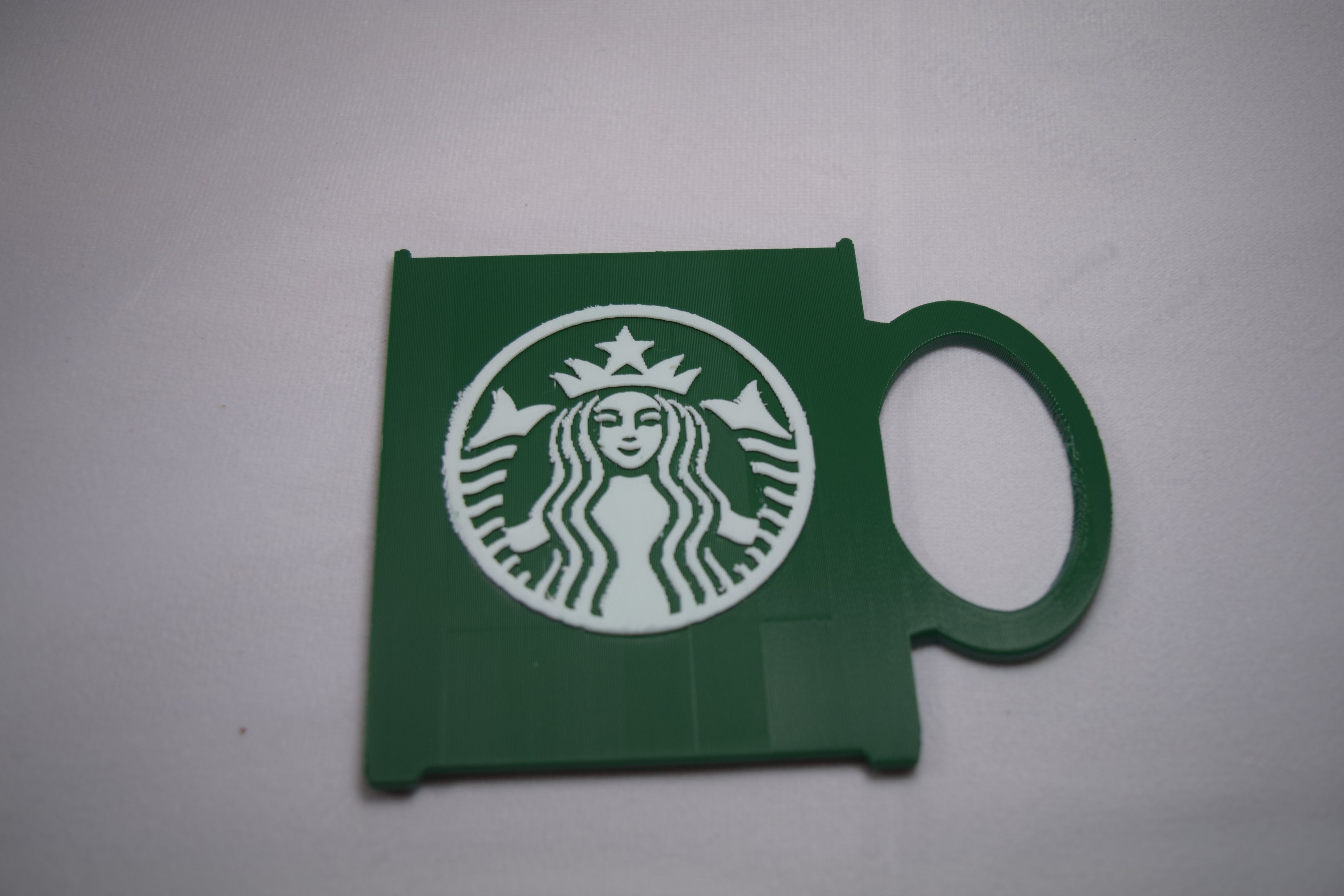 Starbucks Mug Gift Card Holder, green 3D-printed plastic with a white Starbucks logo.