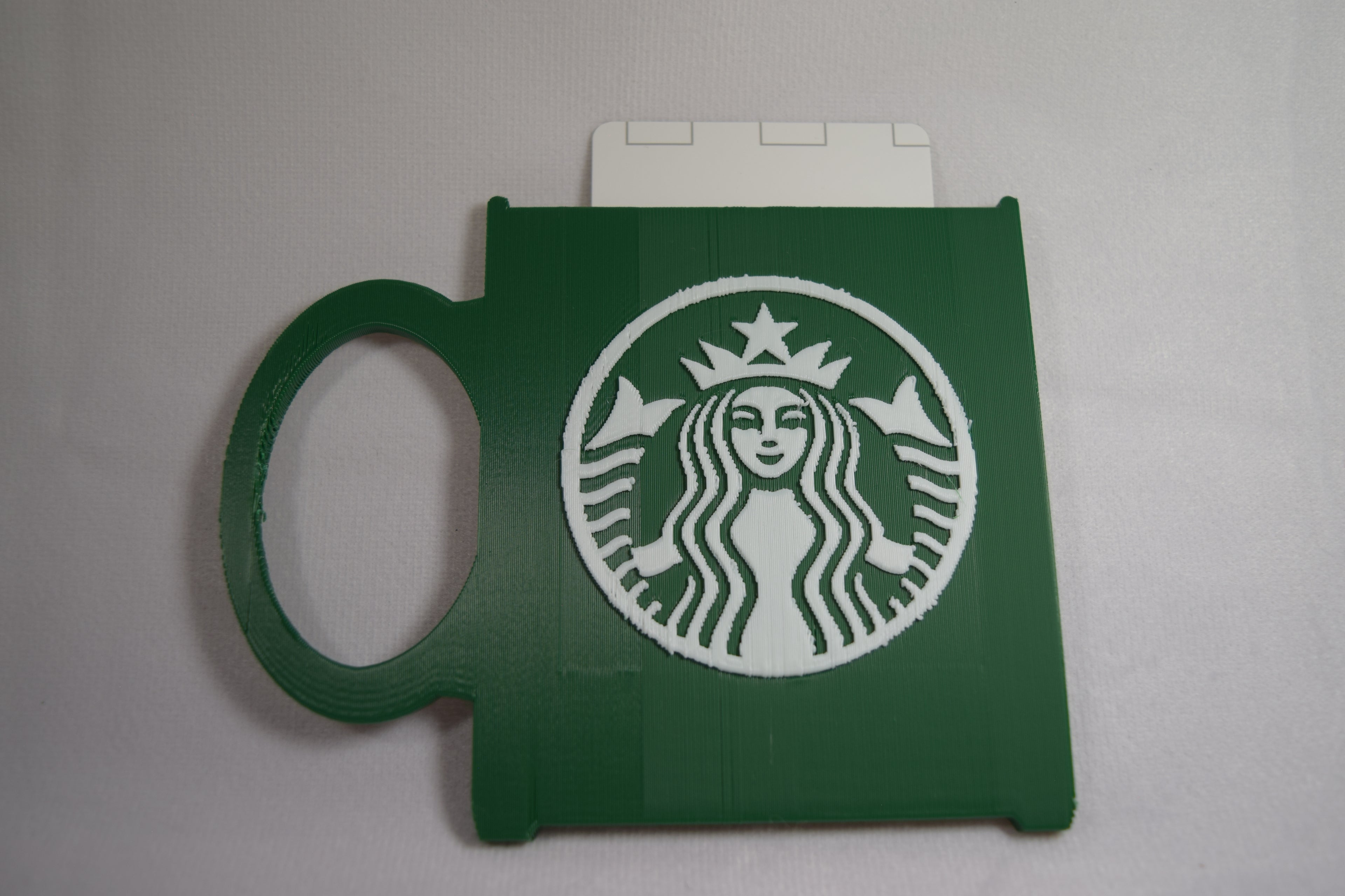 Starbucks mug gift card holder; green 3D-printed accessory with white Starbucks logo.