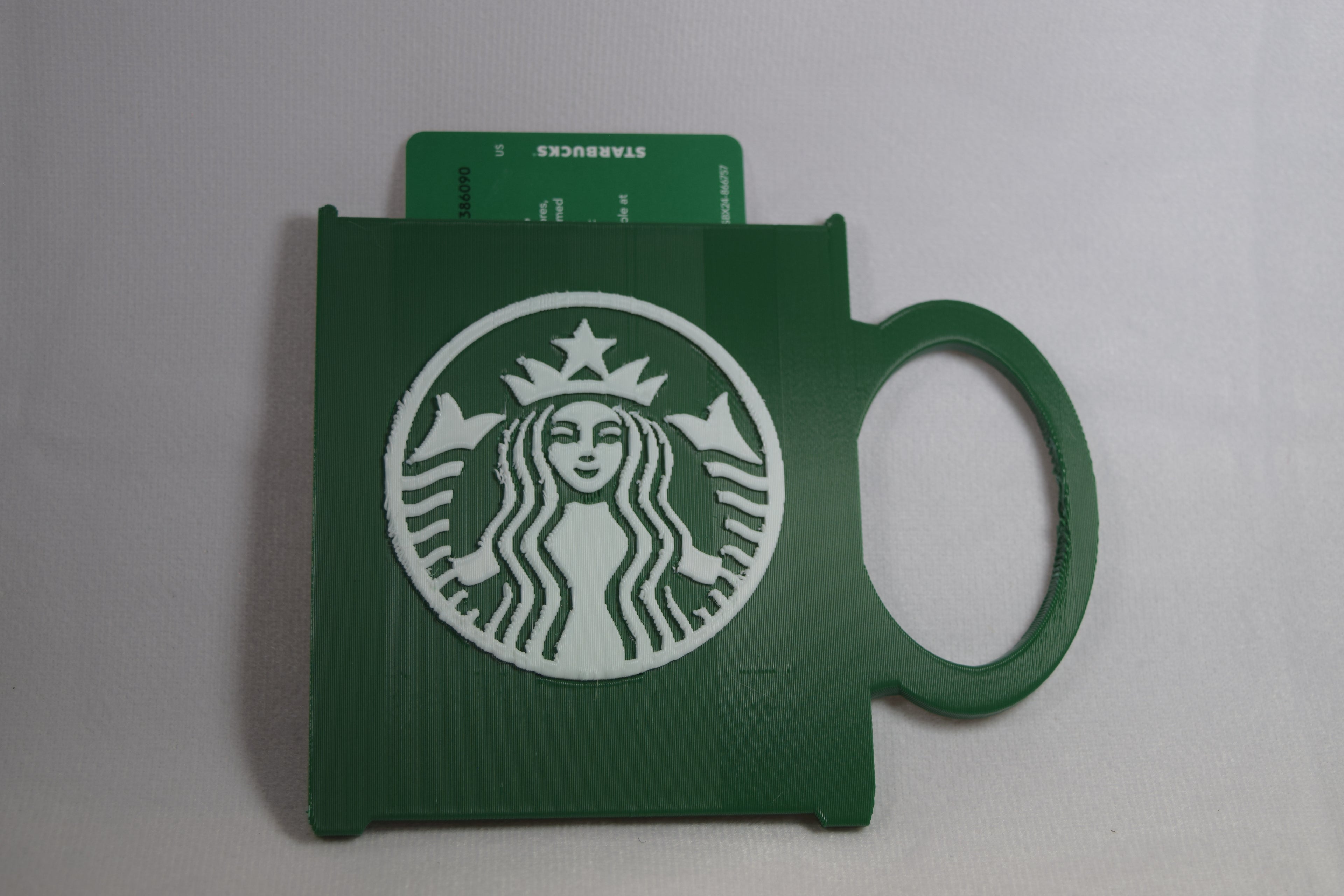 Starbucks mug gift card holder, green 3D-printed with a white Starbucks logo.