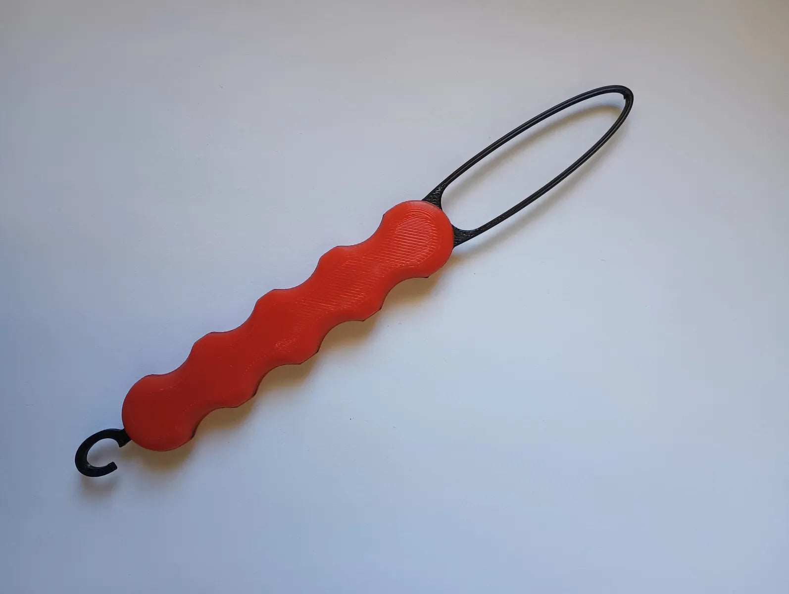 Bryans3dPrints assistive button hook tool with red contoured grip and black loop end