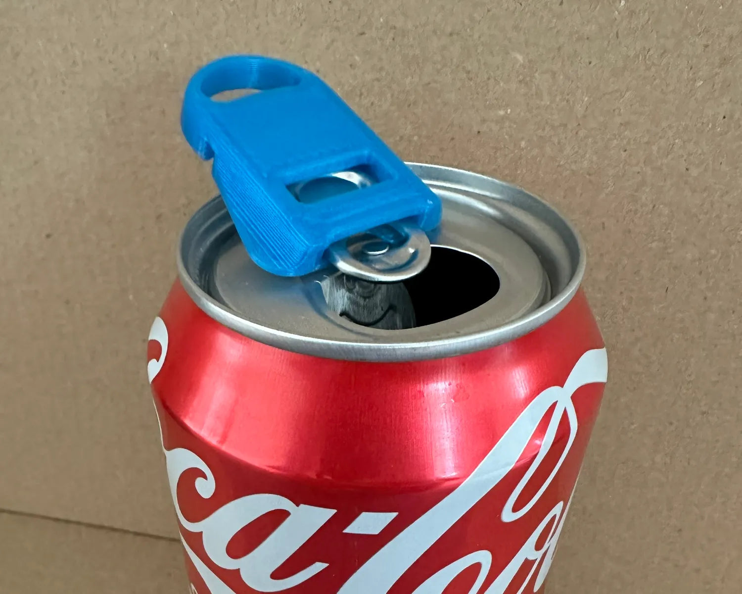 2-in-1 Soda Can Opener & Lid in blue by Bryans3dPrints, shown on a Coca-Cola can.