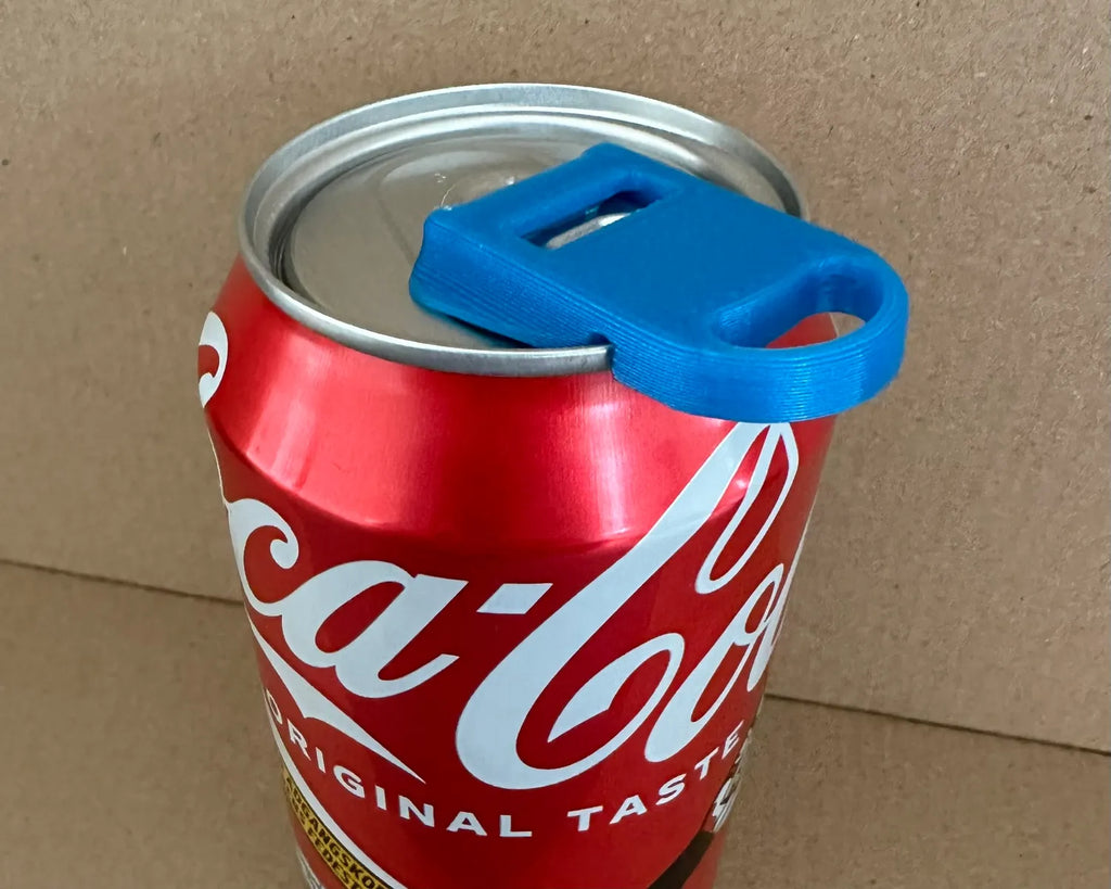 2-in-1 soda can opener lid in blue; reusable spill guard on Coca-Cola can